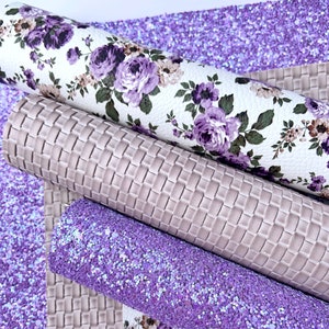 May include: Four sheets of faux leather in various textures and colors. One sheet is a white floral print with purple flowers, one is a light purple glitter, one is a light gray with a woven texture, and one is a light gray with a square texture.