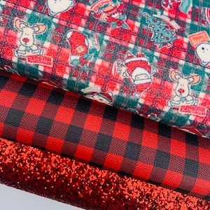 May include: Three sheets of red and black patterned fabric. The top sheet features a Christmas theme with a red and green plaid background and various holiday characters. The middle sheet is a red and black buffalo plaid. The bottom sheet is a red glitter fabric.