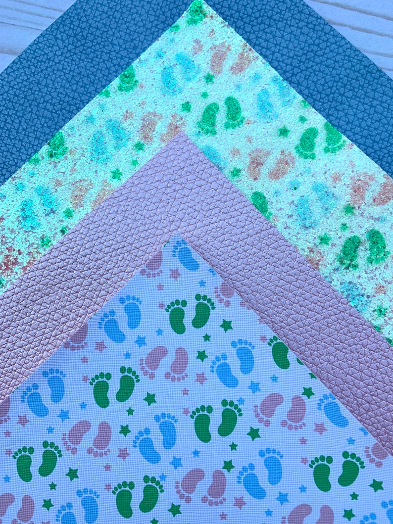 May include: Three fabric swatches, one with a blue glitter pattern, one with a pink leather texture, and one with a white background and a repeating pattern of green and blue footprints and stars.