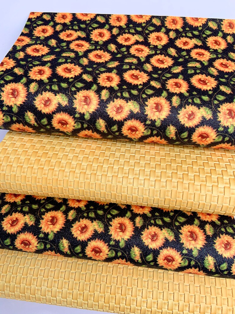 May include: Two pieces of fabric, one with a woven pattern and the other with a sunflower print. The sunflower fabric is black with yellow sunflowers and green leaves. The woven fabric is a light beige.