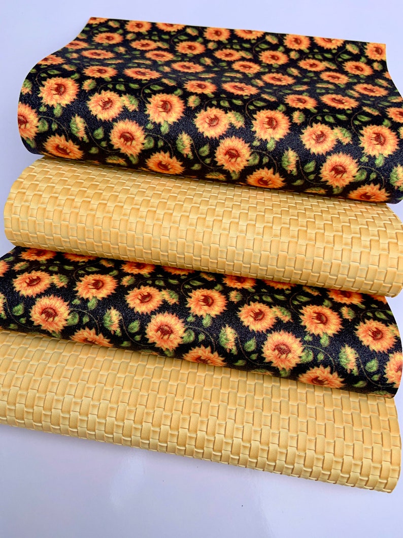 May include: Four pieces of fabric, two with a woven texture and two with a sunflower pattern on a black background.