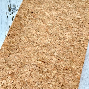 May include: A sheet of natural cork with a light brown color and a textured surface.