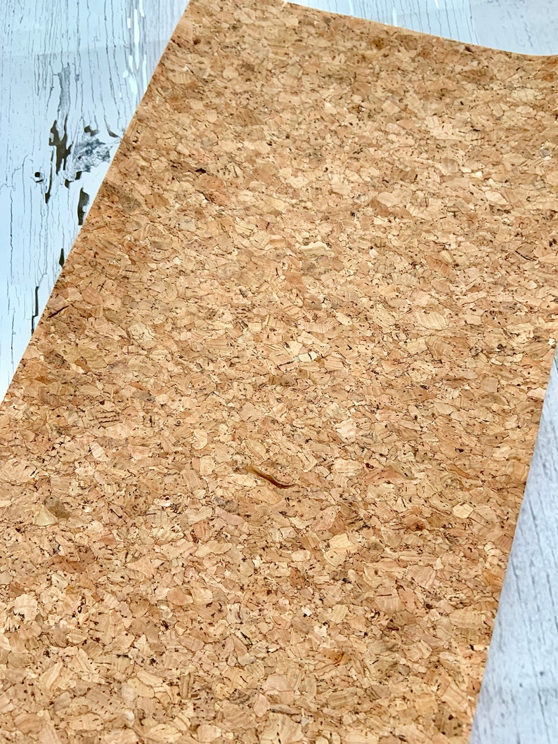May include: A sheet of natural cork with a light brown color and a textured surface.
