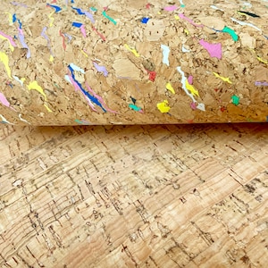 May include: Two pieces of cork fabric, one with a natural brown color and the other with a brown background and colorful flecks and streaks.