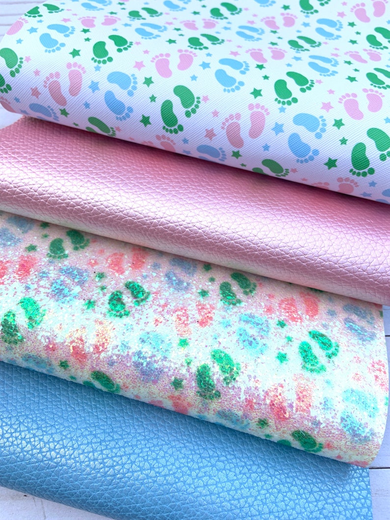 May include: Four different fabric swatches, stacked on top of each other. The top swatch is white with a repeating pattern of green and blue footprints and white stars. The second swatch is a light pink faux leather. The third swatch is a white fabric with a light blue and pink glitter pattern. The bottom swatch is a light blue faux leather.