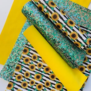 May include: A set of four fabric sheets featuring a sunflower pattern. The sheets are in black and white stripes with yellow sunflowers. One sheet is solid yellow, and another is a green and silver glitter fabric.