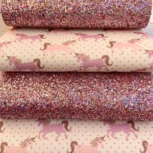 May include: Four pieces of pink and white fabric with a unicorn pattern. The top two pieces are pink glitter fabric. The bottom two pieces are white fabric with pink unicorns and pink polka dots.
