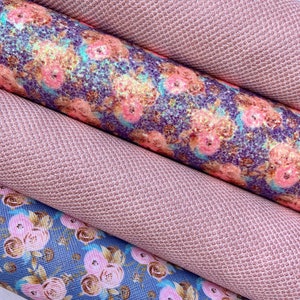 May include: Close-up of several rolls of fabric. Two rolls are a solid, textured, light pink color. The other two rolls have floral patterns in shades of pink, blue, and purple. The fabric appears to be faux leather or vinyl.