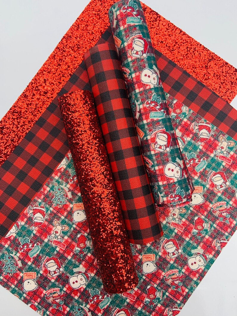 May include: A set of five red and black patterned fabric sheets. The sheets feature a red glitter fabric, a red and black buffalo plaid fabric, and three different red and green patterned fabrics with Christmas-themed illustrations.