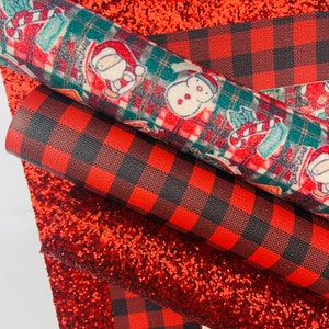 May include: Three sheets of fabric with a Christmas theme. The top sheet is red glitter fabric. The middle sheet is red and black buffalo plaid fabric. The bottom sheet is a white background with a red, green, and white Christmas pattern.