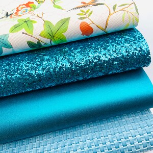 May include: Four different fabric swatches in shades of blue. The top swatch features a white background with a floral pattern, the second swatch is a sparkly turquoise blue, the third swatch is a solid turquoise blue, and the bottom swatch is a textured light blue.