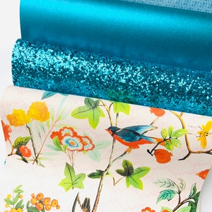 May include: A set of four teal fabric sheets with different textures. The top sheet has a woven pattern, the second sheet is a solid colour, the third sheet has a glitter finish, and the bottom sheet has a floral print with birds.