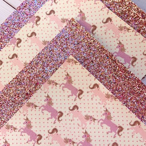 May include: Three sheets of pink glitter paper with a unicorn pattern. The paper has a white background with pink polka dots and pink unicorns.