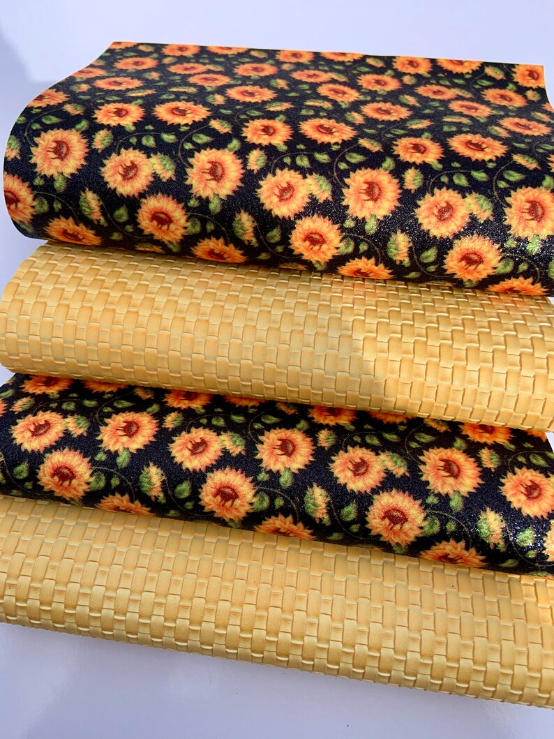 May include: Four pieces of fabric, two with a woven texture and two with a sunflower print on a black background.