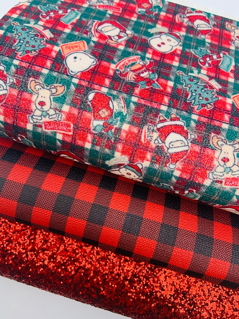 May include: Three pieces of fabric: a red and green plaid fabric with a Christmas theme, a red and black buffalo plaid fabric, and a red glitter fabric.