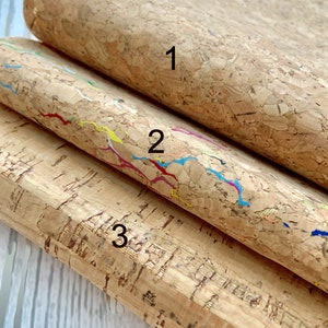 May include: Three pieces of cork fabric with different patterns. The top piece is plain, the middle piece has colorful lines, and the bottom piece has a gold flecked pattern. The pieces are labeled 1, 2, and 3.