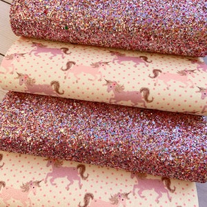 May include: Four pieces of fabric, two are pink glitter fabric and two are white fabric with pink unicorn silhouettes and pink polka dots.