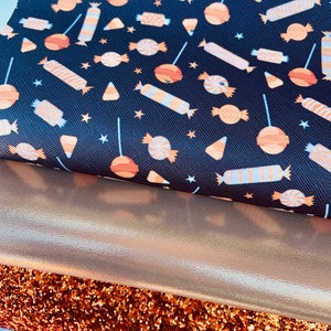 May include: Three fabric swatches: a black fabric with a repeating pattern of orange and white candy, a gold metallic fabric, and a copper glitter fabric.