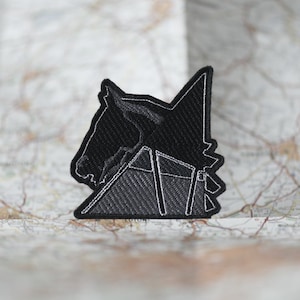 May include: Black embroidered patch of a horse's head with a geometric design. The patch is on a white background.