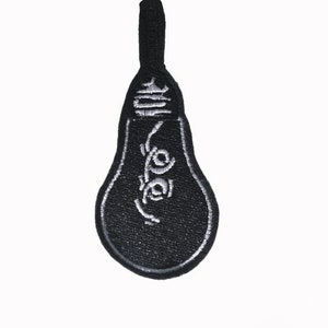 May include: Black light bulb shaped patch with a white embroidered filament design.