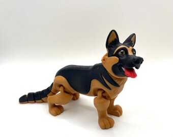 May include: A toy German Shepherd dog figurine in black and tan. The dog has a red tongue sticking out and is posed in a standing position. The toy is made of plastic and has articulated joints.