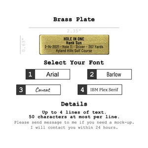 May include: A gold-colored brass plate with the text "HOLE IN ONE Hank Sun 2-14-2021 - Hole 11 - Driver - 367 Yards Hyland Hills Golf Course". The plate is 2.35 inches wide and 0.63 inches tall. The text is in a black font. There are four font options to choose from: Arial, Barlow, Caveat, and IBM Plex Serif.