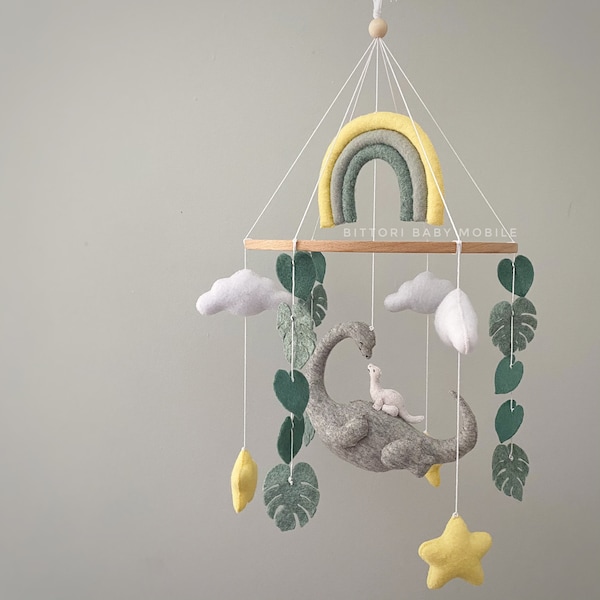 Dinosaur mobile with rainbow cloud star monstera. Baby shower gift idea in grey yellow color palette. Pregnancy gift or newborn or new mom.