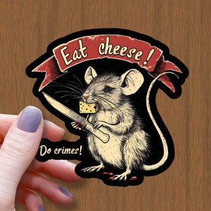 May include: A black and white illustration of a mouse holding a knife and a piece of cheese. The mouse is wearing a red bandana with the text "Eat cheese!" and the text "Do crimes!" is below the mouse.
