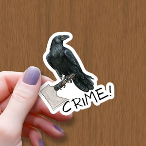May include: A black raven perched on a white axe with the word "CRIME!" written in black below it.