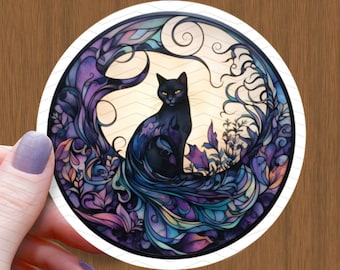 May include: A black cat with yellow eyes sits in a circle of purple, blue, and green stained glass-like floral designs. The cat's tail is curled around its body and blends into the background.