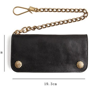 May include: Black leather wallet with a chain and two brass studs. The wallet measures 9.8 inches by 19.3 inches.