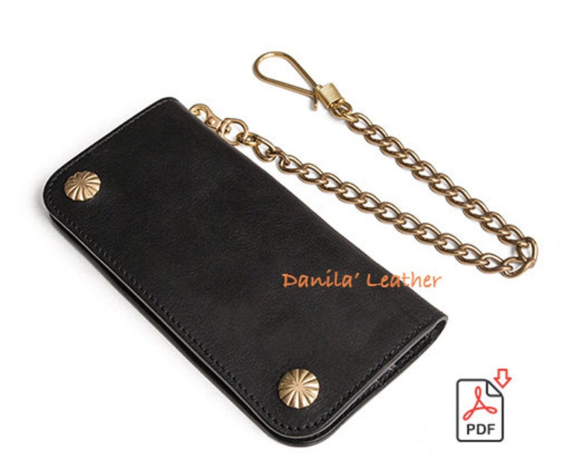 May include: Black leather wallet with a gold chain and brass accents. The wallet has two decorative studs on the front. "Danila' Leather" is printed on the wallet.