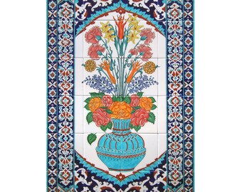 May include: A decorative tile panel with a colourful floral design. The image shows a turquoise vase filled with orange roses, pink carnations, and yellow daffodils. The panel is framed with a detailed border of blue, white, and orange patterns.