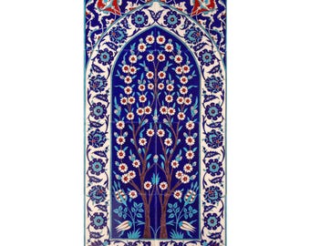 May include: A blue and white ceramic tile with a traditional Turkish design featuring a stylised tree with white flowers and blue leaves. The tile is framed by a border of intricate floral patterns.