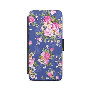 May include: A blue phone case with a floral pattern. The flowers are pink, white, and yellow. The case has a flap that closes with a magnetic clasp.