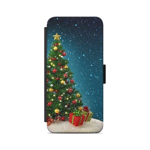 May include: A Christmas tree decorated with red and gold ornaments and lights, with presents underneath, against a blue background with falling snow.