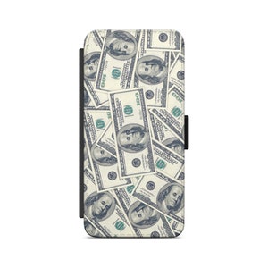 May include: A black leather phone case with a pattern of 100 dollar bills. The case has a flap that closes with a snap.