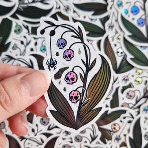 Revive- holographic vinyl sticker, weatherproof, waterproof sticker, lilly of the valley skulls, cute and spooky flower, studio ao design