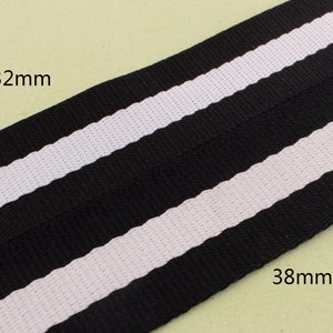May include: Black and white striped ribbon with a width of 32 mm and 38 mm.