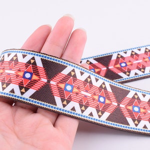 May include: Brown, red, white, and blue patterned woven trim with a geometric design.
