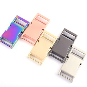 May include: A selection of metal buckles in different colours: iridescent, rose gold, gold, gunmetal, and silver. The rectangular buckles have a sliding mechanism for secure fastening. Suitable for crafts or accessories.