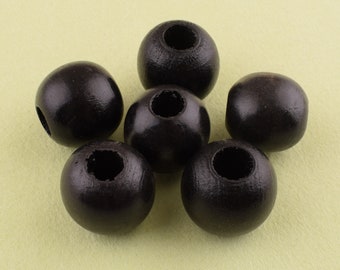 May include: Six black wooden beads with a hole in the center. The beads are round and smooth.