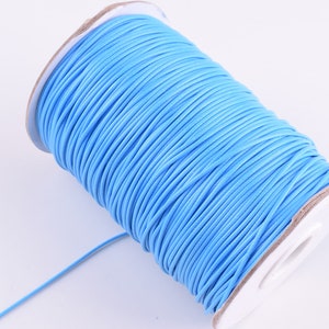 May include: A spool of light blue waxed cord, perfect for jewelry making, crafts, and macrame projects.