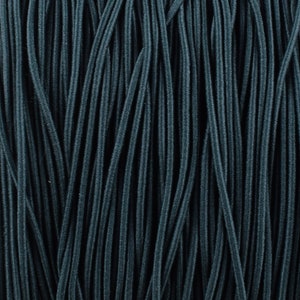May include: Close-up of a bundle of dark teal elastic cord. The cord is arranged in parallel lines, creating a textured background.