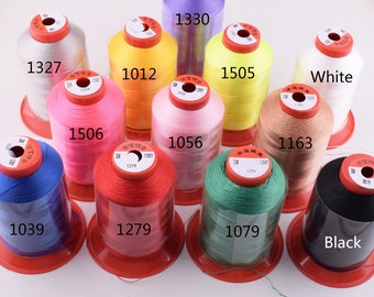 May include: Assortment of spools of thread in various colors, including red, pink, yellow, green, blue, white, and black. Each spool has a label with a number, such as 1327, 1012, 1506, 1330, 1056, 1505, 1163, 1279, 1079, and 1039.