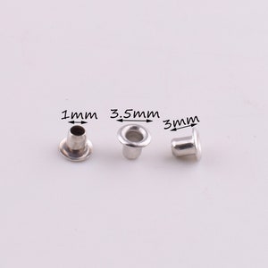May include: Three silver eyelets with different sizes: 1 mm, 3.5 mm, and 3 mm. The eyelets are on a white background.