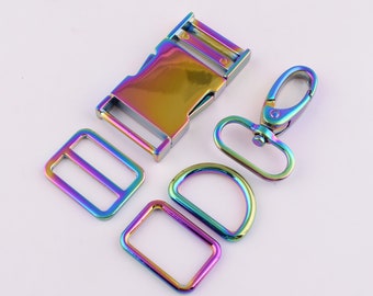May include: A set of five rainbow-colored metal hardware pieces for crafting. The set includes a buckle, a slider, a D-ring, a trigger snap, and a lobster clasp.