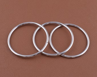 May include: Three silver metal rings, interlocking with each other. The rings are smooth and shiny.