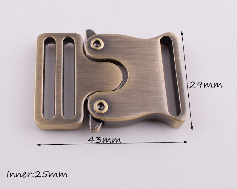 May include: Antique gold metal buckle with a 25 mm inner width, measuring 43 mm long and 29 mm wide.