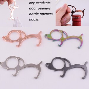 May include: Four dog-shaped keychains in different colors: rose gold, rainbow, silver, and black. Each keychain has a loop for attaching keys and a bottle opener.